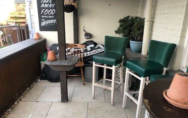 The smoking area at the bar featured more bar stools and a sign advertising takeaway food via Uber Eats