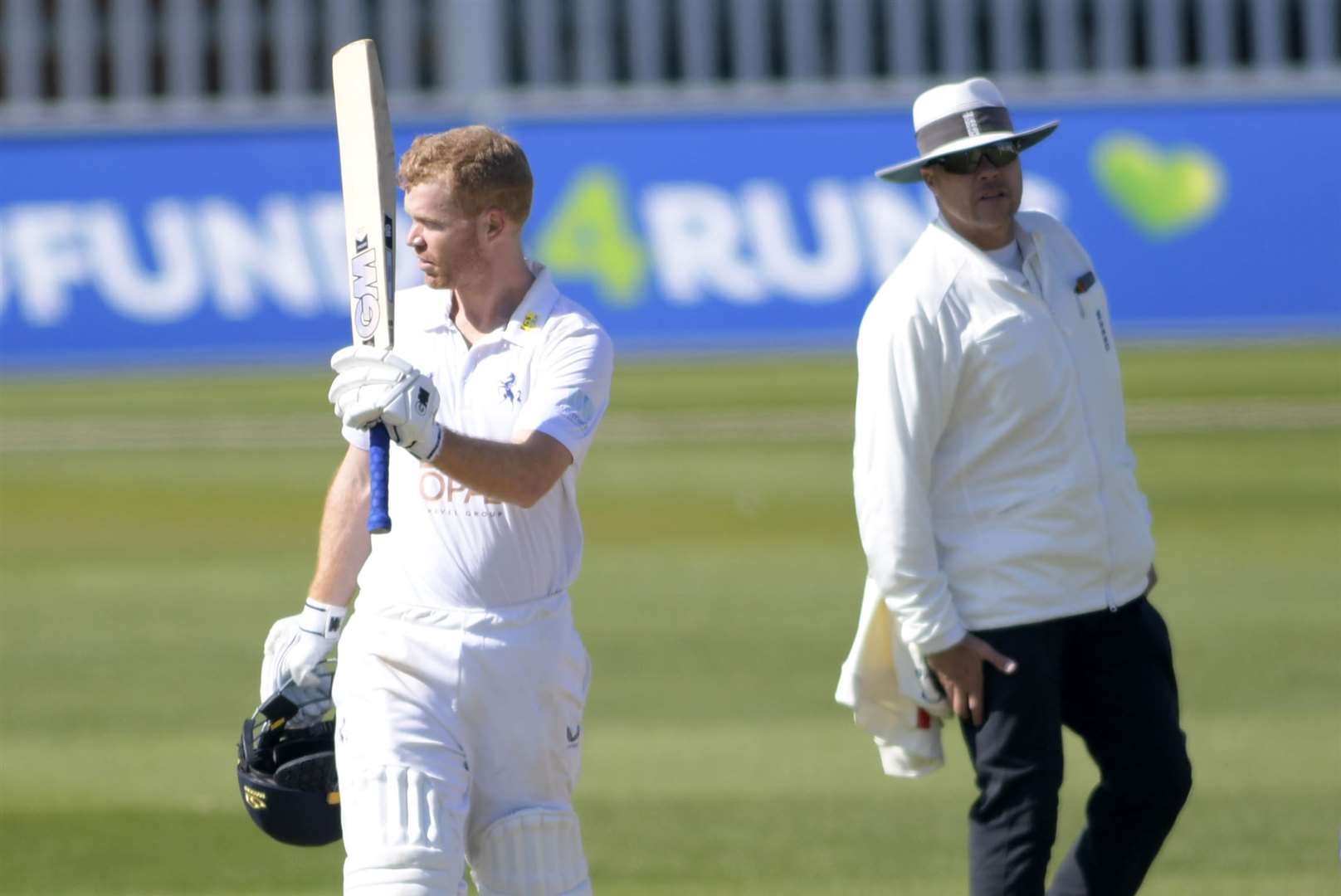 Ben Compton raises his bat after reaching his hundred. Picture: Barry Goodwin