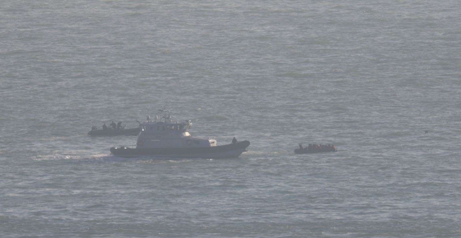 A dinghy with a Border Force vessel to aid it.The craft on the left is thought ot be a Border Force RHIB. Picture: UKNIP