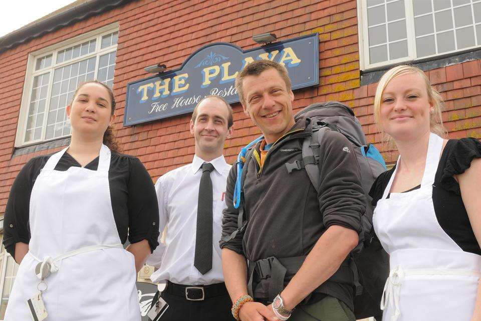 Adam Short is walking around the UK coastline. He's pictured here with staff outside the Playa pub in Minster.