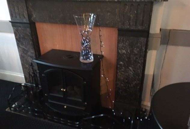 I'm not sure if the log burner works or is just for show, but the flashing fairy lights in a vase definitely don't seem a good idea to me