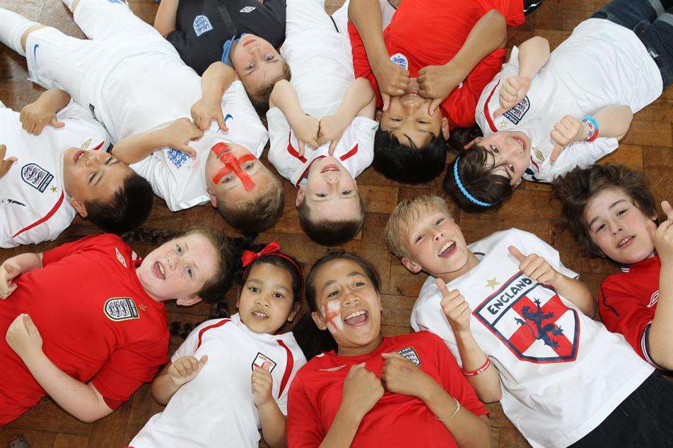 Children sporting England colours celebrate the Football World Cup in at South Borough Primary School in Maidstone