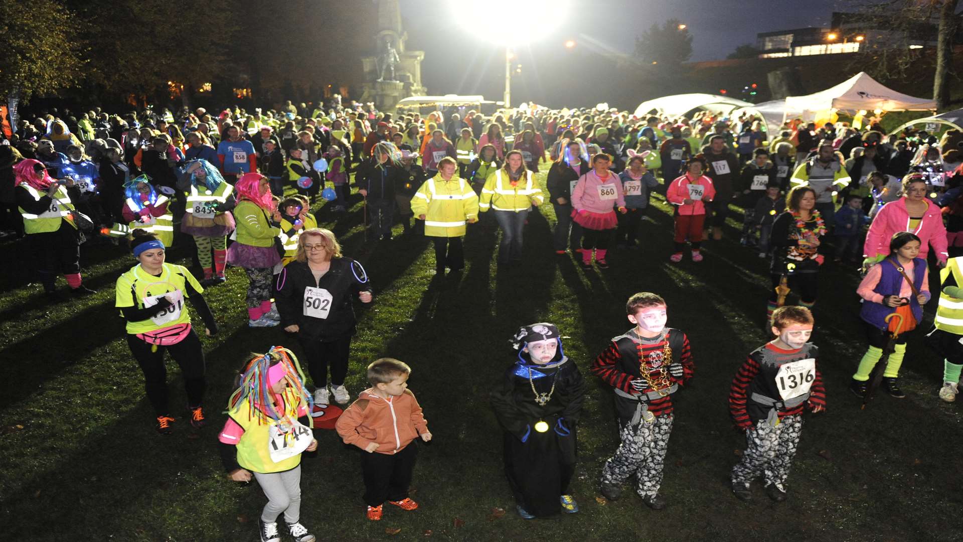 Colourful participants gather in Canterbury's Dane John Gardens for Light up the City.