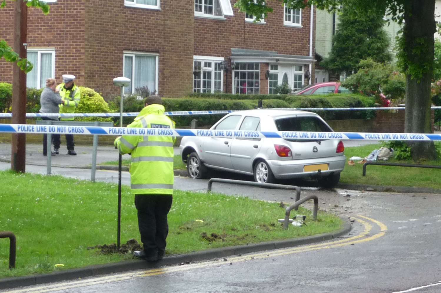 Police investigators in Twydall where a man died after crashing his car