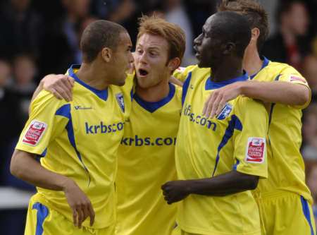 Curtis Weston is congratulated by team-mates of scoring Gillingham's winner at Rochdale