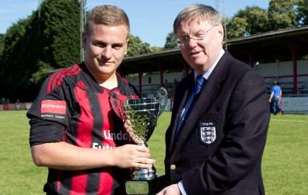 Kent FA chairman Barry Bright presents the Anniversary Trophy to Jack Jeffrey