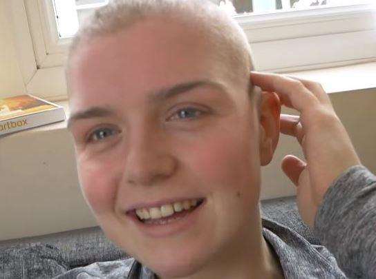 Emily Hayward puts on a brave smile after her headshave