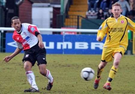 Welling boss Jamie Day, right, closes down former Wings defender Tony Sinclair on Saturday