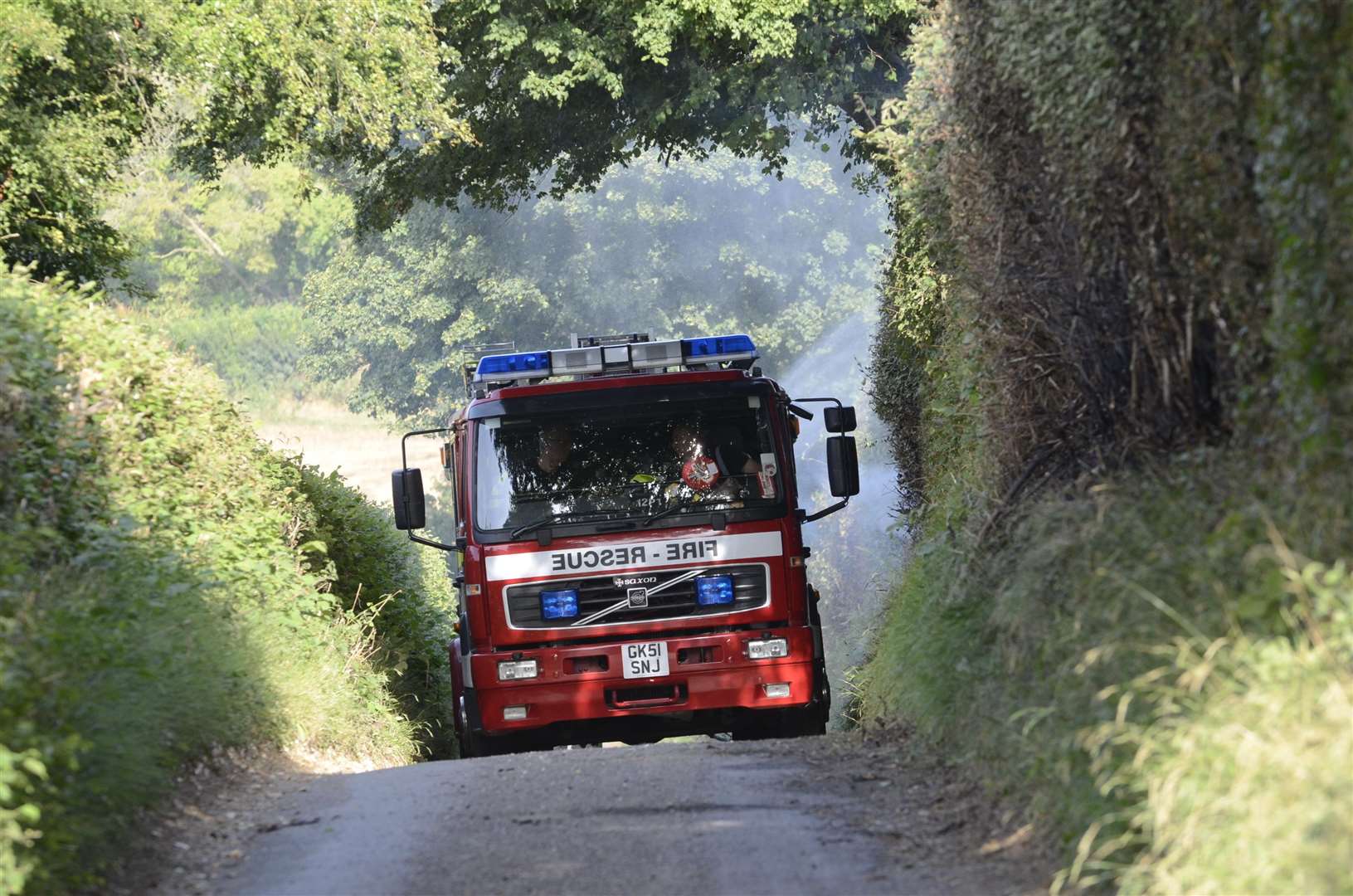 Crews damping down after a corn fire. Stock image