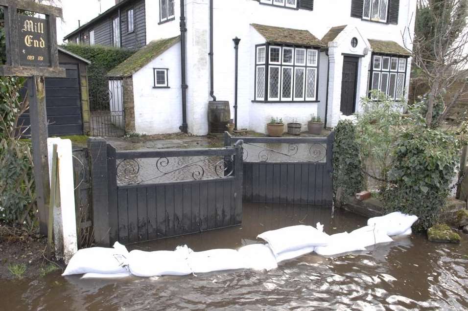 Sandbags surround a house in Seaton. Picture: Chris Davey