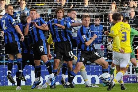 Kevin Nicholson splits the Gillingham defence to claim an injury time equalser