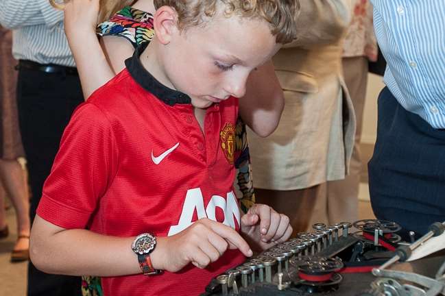 A young visitor examines items at the exhibition