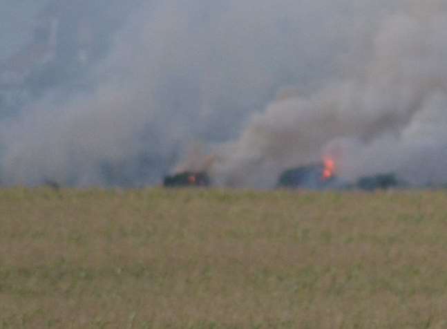 Flames are seen rising from the field. Picture: Chris Kidman