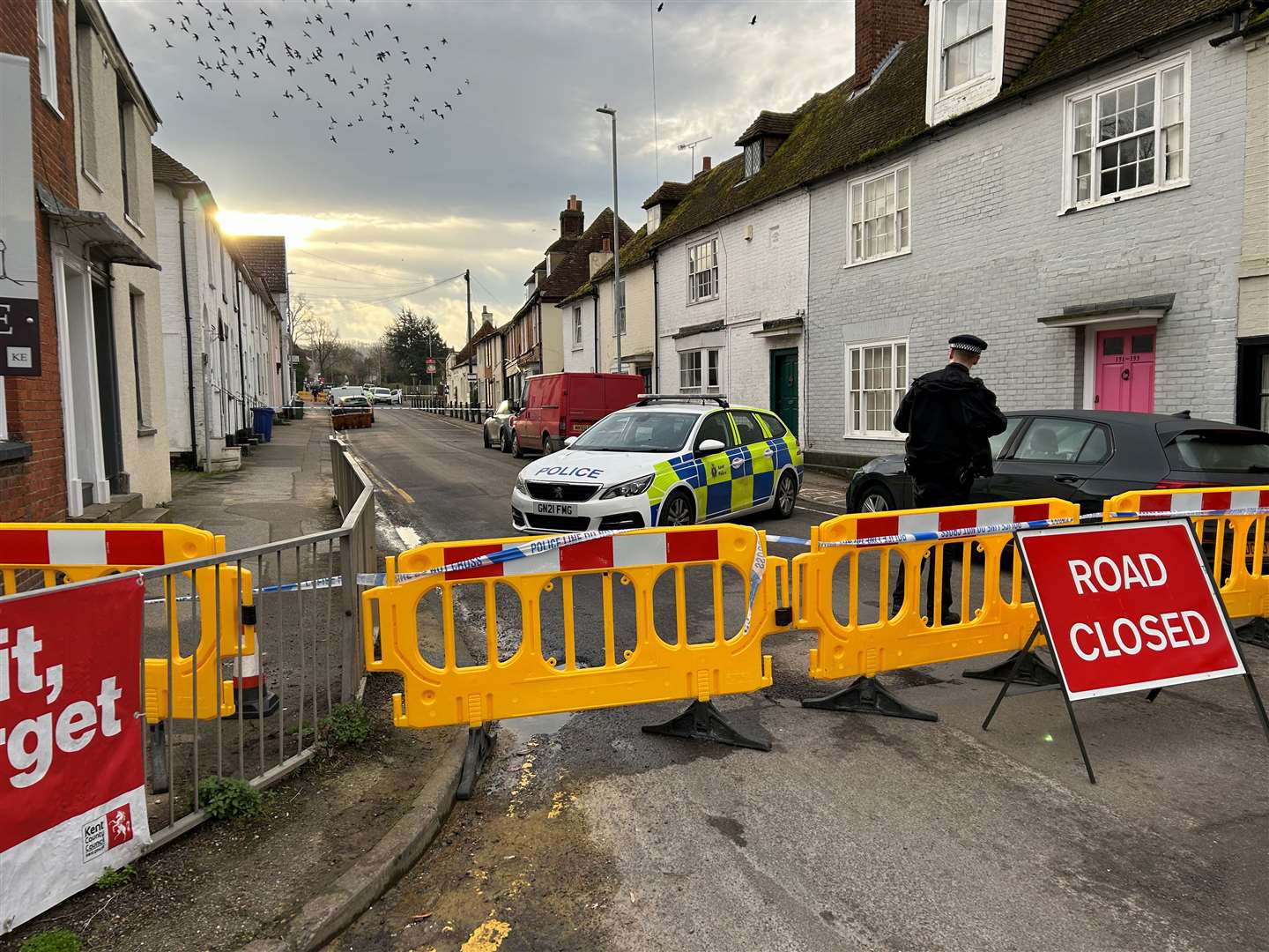 Police have cordoned off the main route through a village after unconfirmed reports of a stabbing