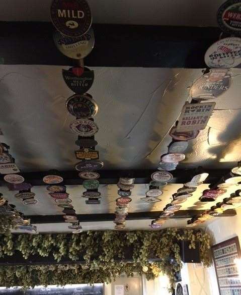 Old beer pump clips are not discarded when they’re finished with, instead they are turned into ceiling decorations