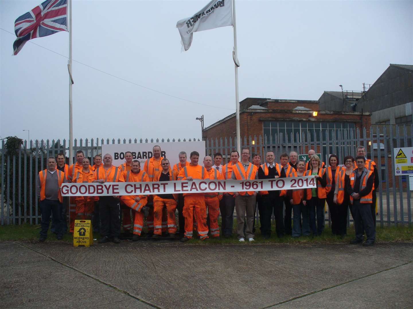 The workforce of Bombardier's Chart Leacon rail depot gather to mark its closure in 2014