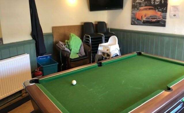 The small room, to the left hand side of the main bar, contained a pool table and the pub’s second dartboard, but it was also being used for storage