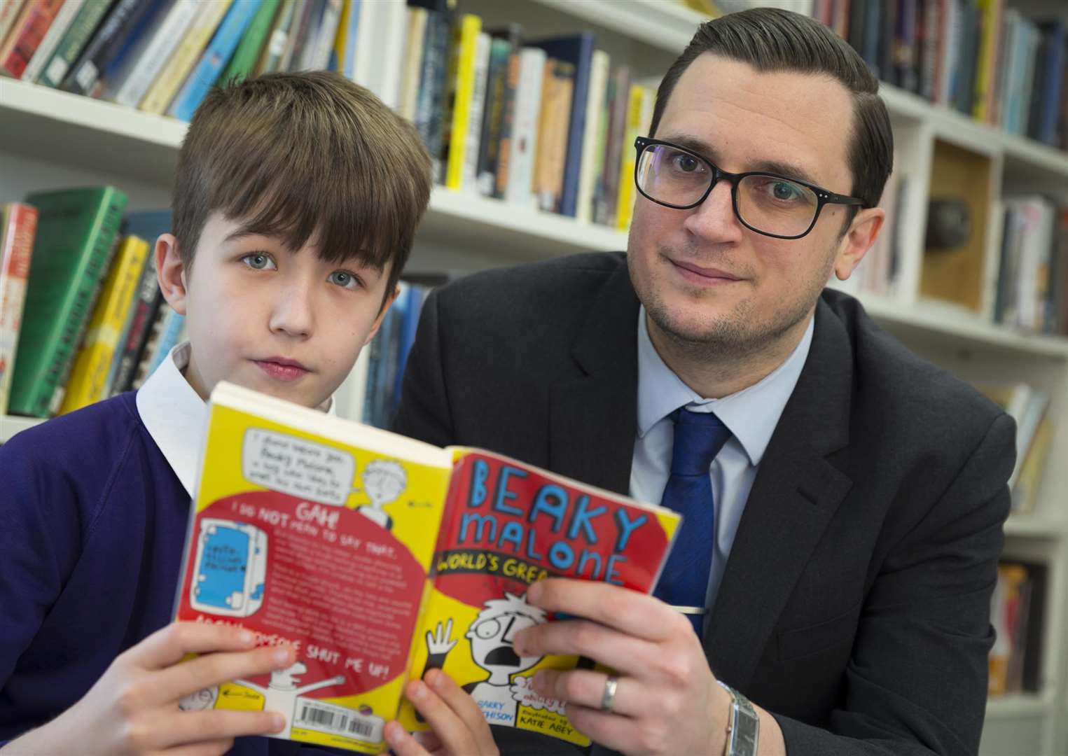 From left, Charlie Dobson of Canterbury Primary School and Jonathan Fullarton of McCabe Ford Williams at the launch of the Kent Literacy Awards. (1525866)