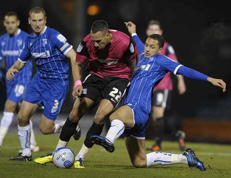 Lewis Montrose puts in a tackle as Andy Frampton looks on