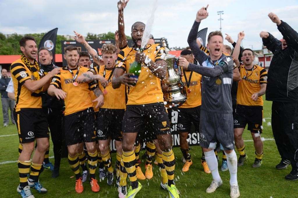 Captain Lee Worgan collects the National League South play-off final trophy for Maidstone. Picture: Gary Browne
