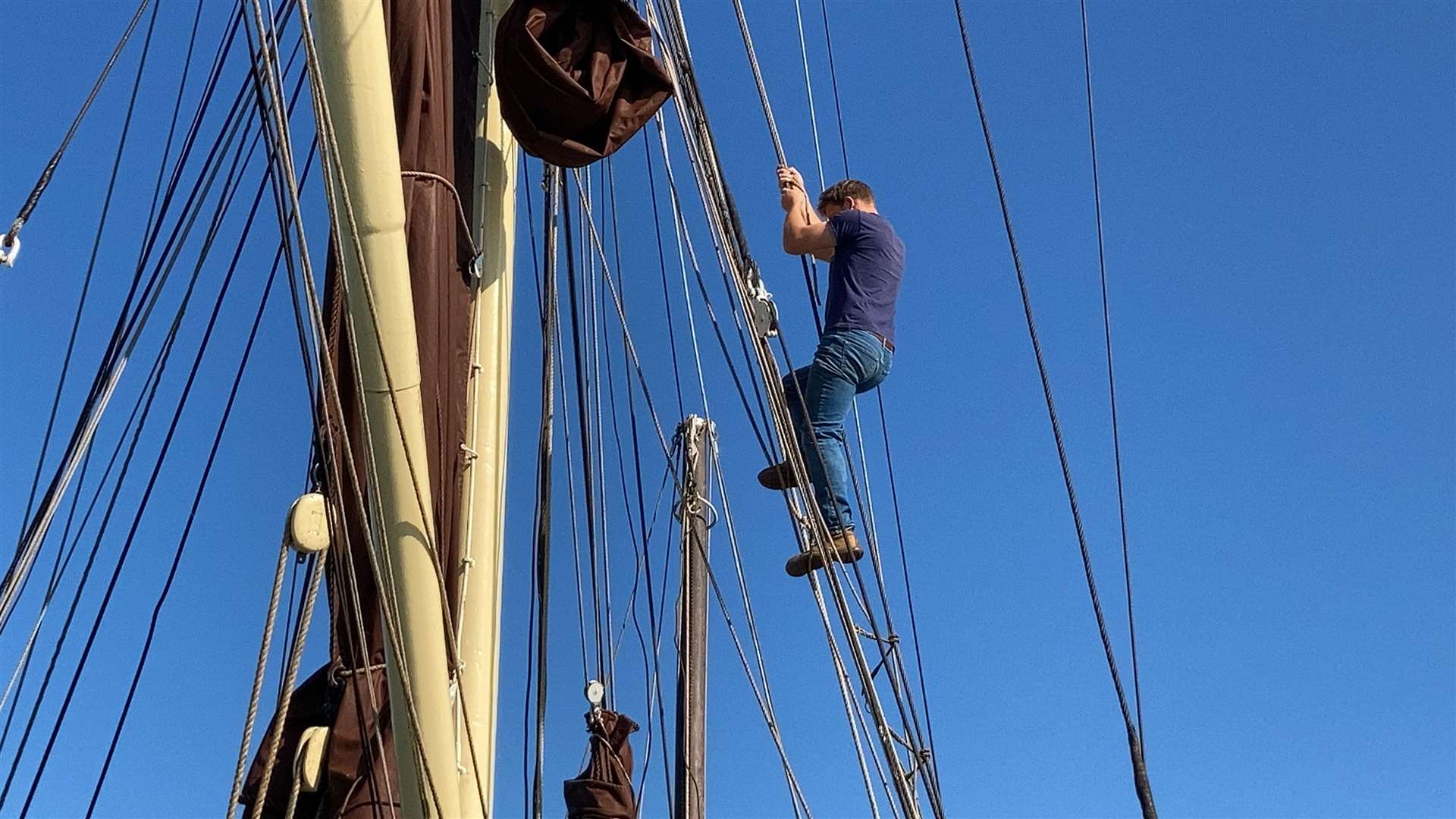 Man the rigging: Ed Gransden shins up the ropes aboard the Edith May