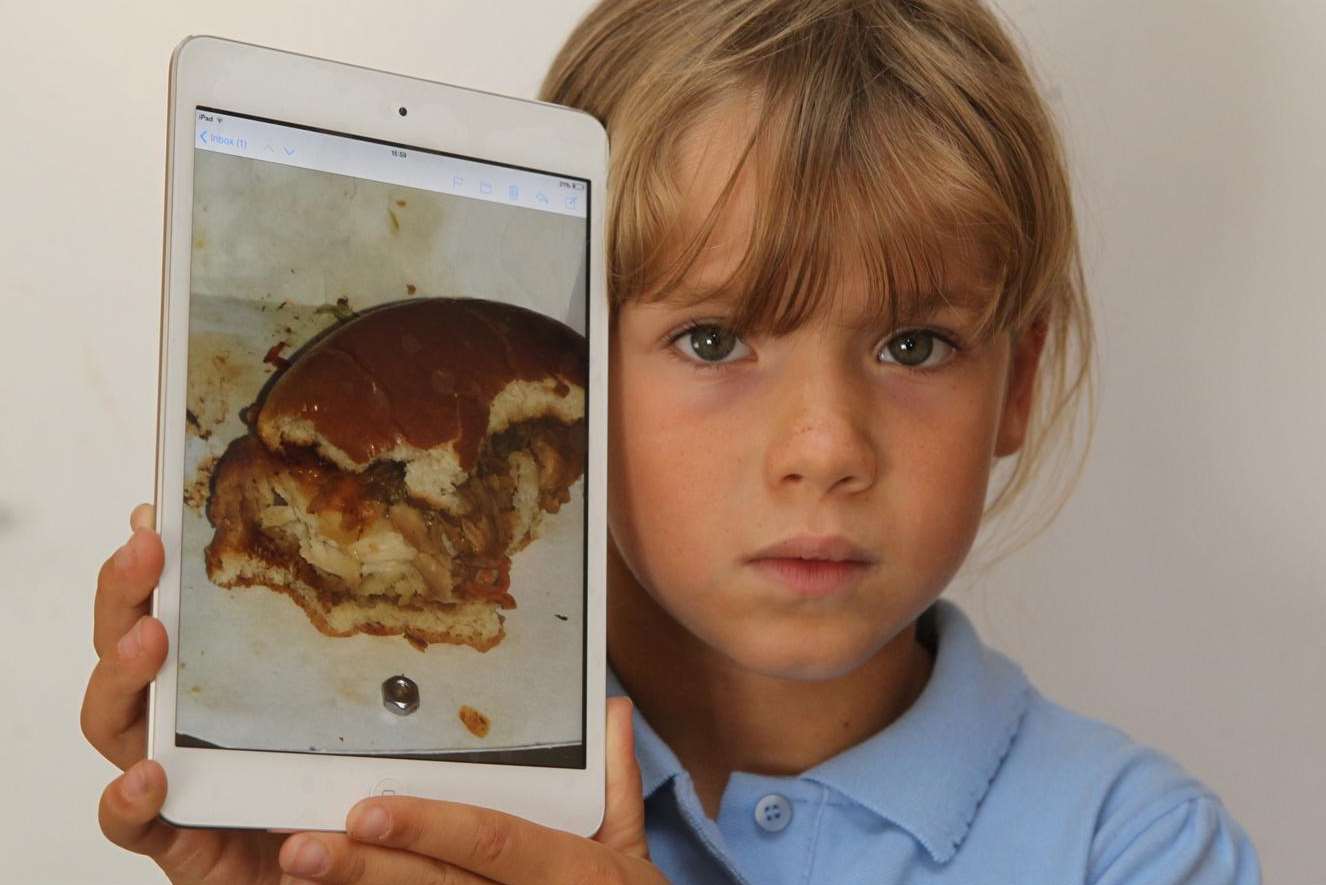 Leah Neat with a picture of the metal nut she found in a KFC burger bought in Gravesend