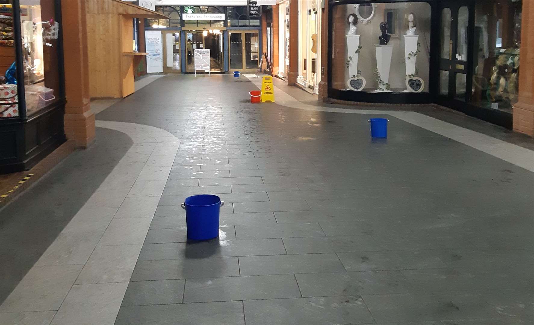 Buckets placed in the Royal Star Arcade to catch the water leaking through