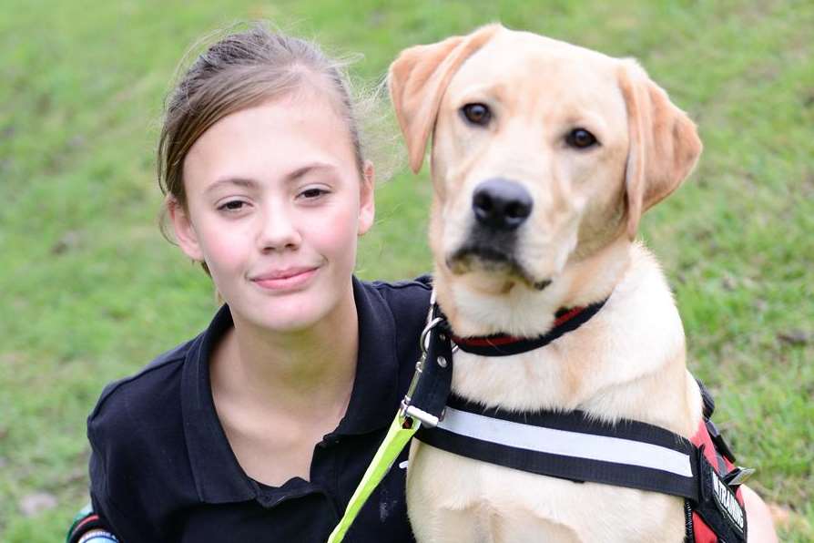 Sophie-Alice Pearman, 11, in the garden with Scooby her medical assistance dog