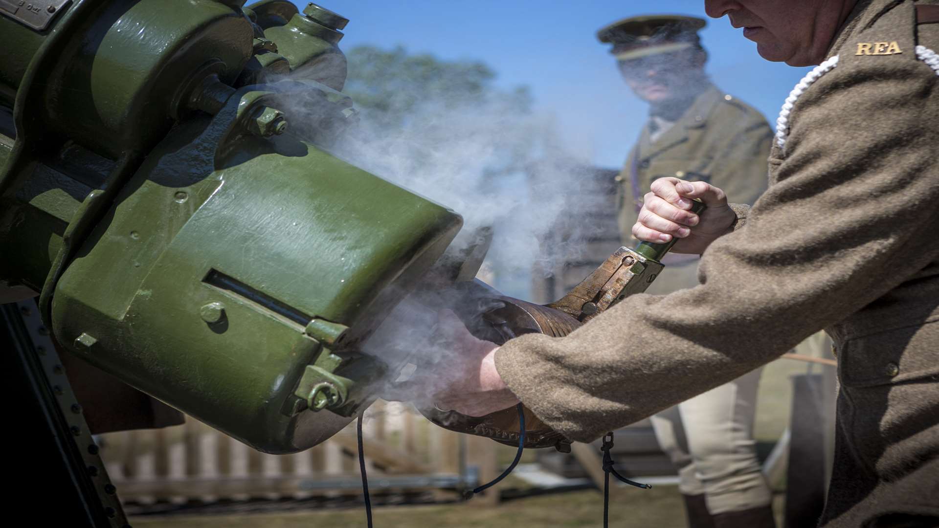 A costumed volunteer removes a shell casing from the restored anti aircraft gun at Dover Castle
