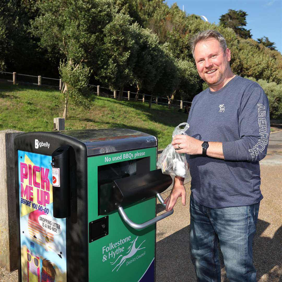 Cllr Stuart Peall with a Big Belly Bin before in the Lower Leas Park