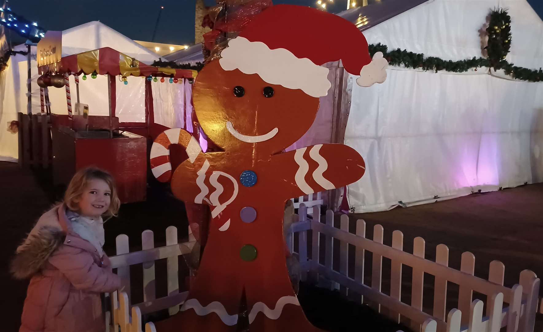 Time for a photo with the giant gingerbread man while we wait to go in