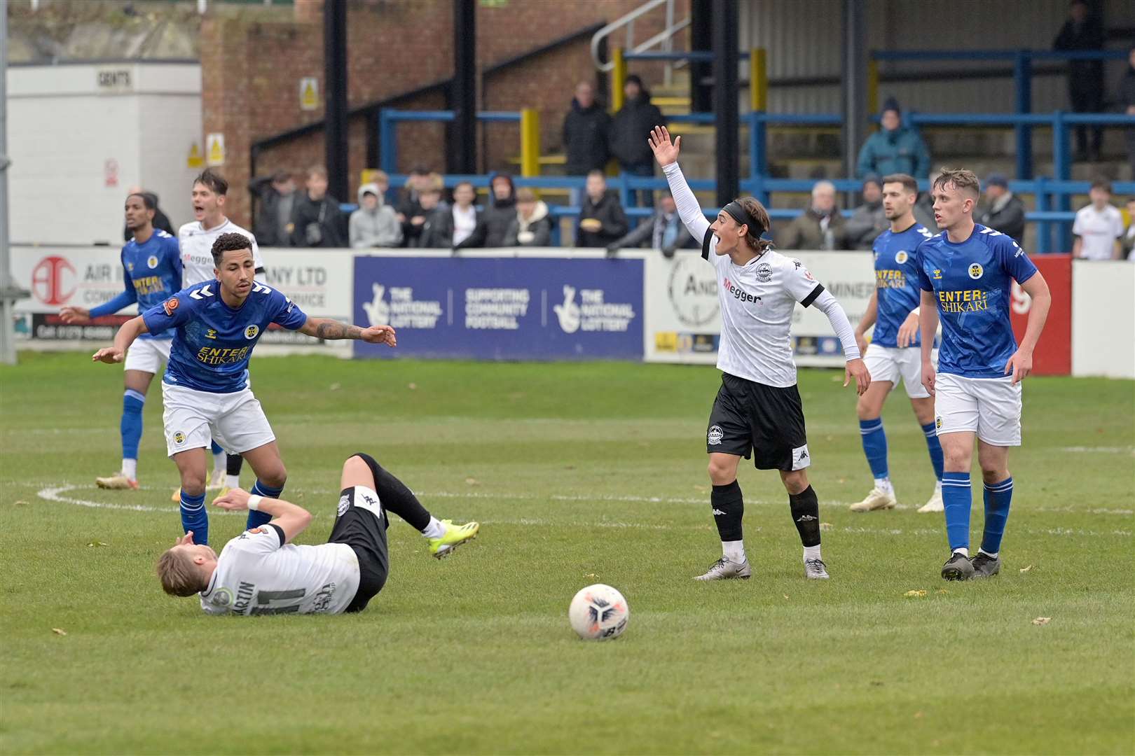 Dover midfielder George Wilkinson appeals as Lee Martin goes down. Picture: Stuart Brock