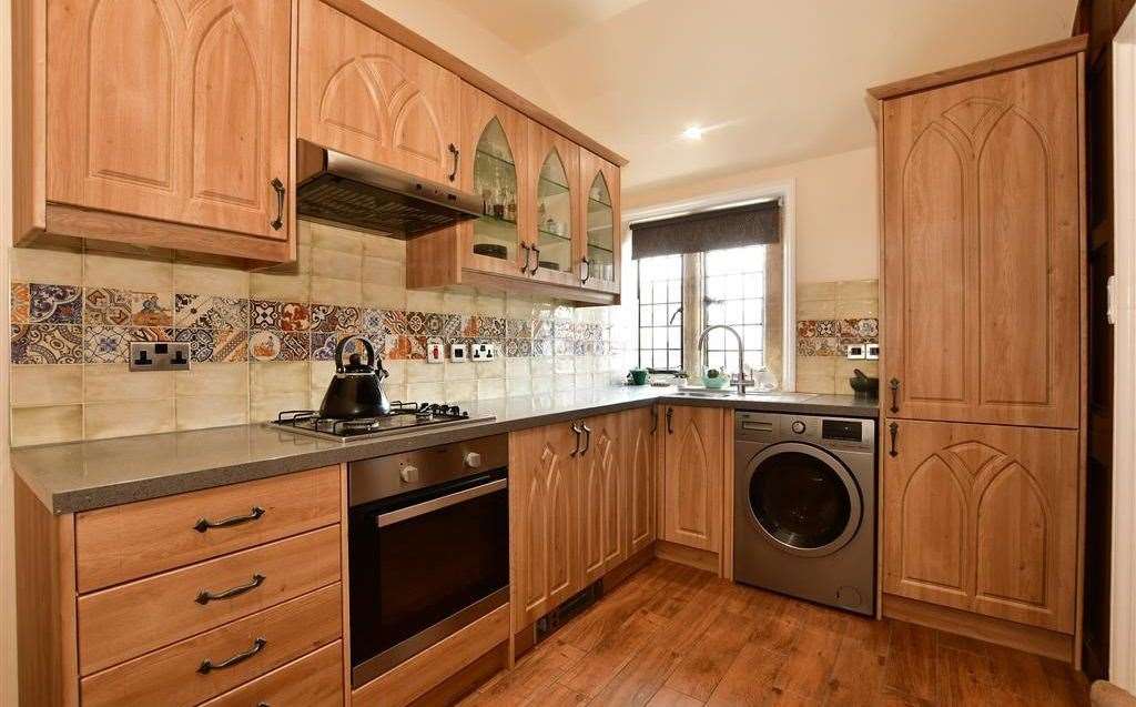 The kitchen is panelled and comes with integrated appliances. Picture: Fine and Country