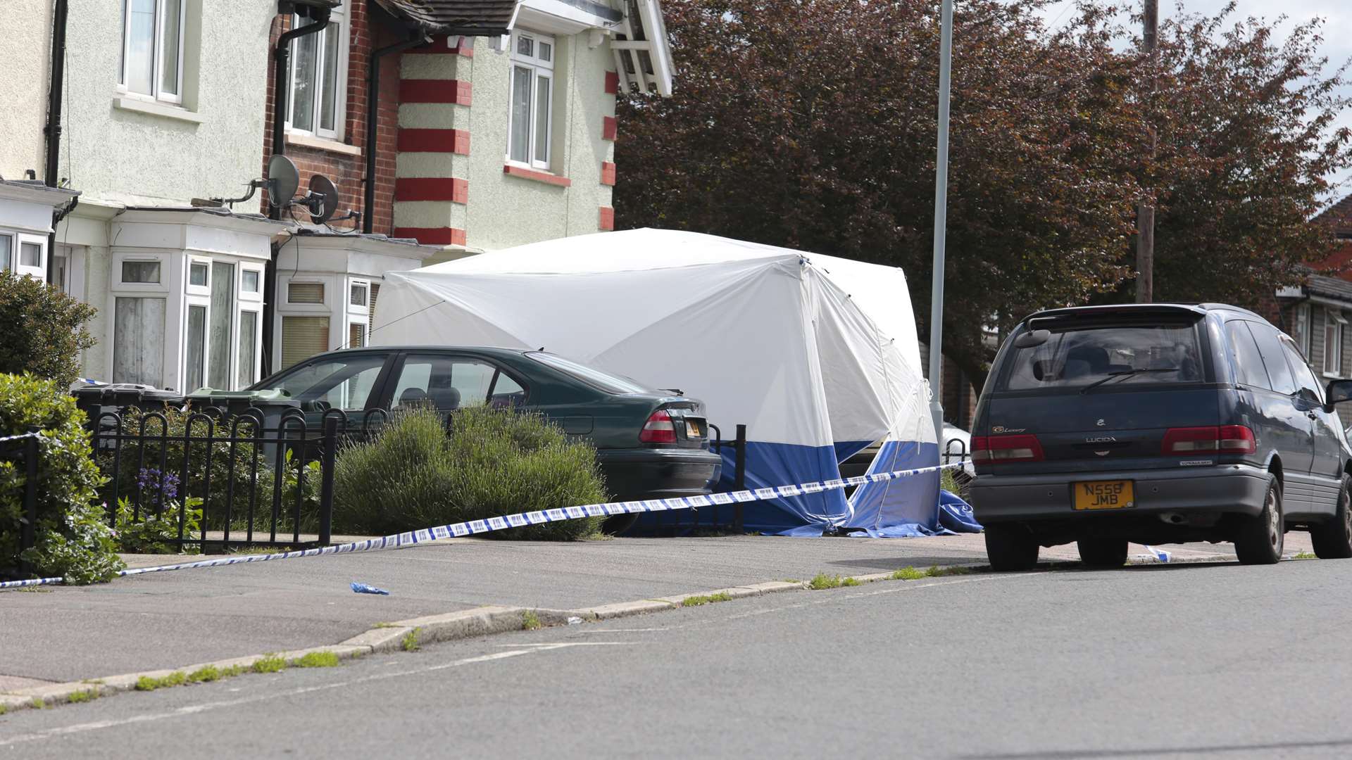 Police and forensic teams at the scene of the murder.