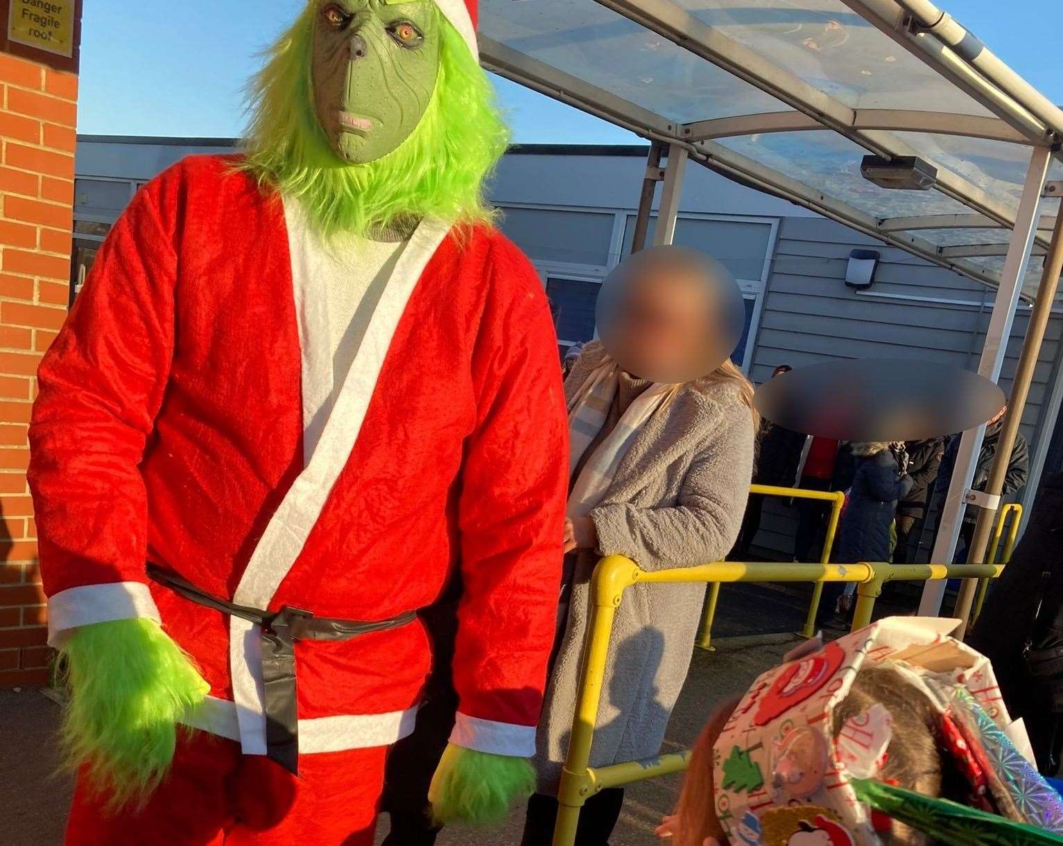 Nick Denham dressed as the Grinch outside Grove Park primary