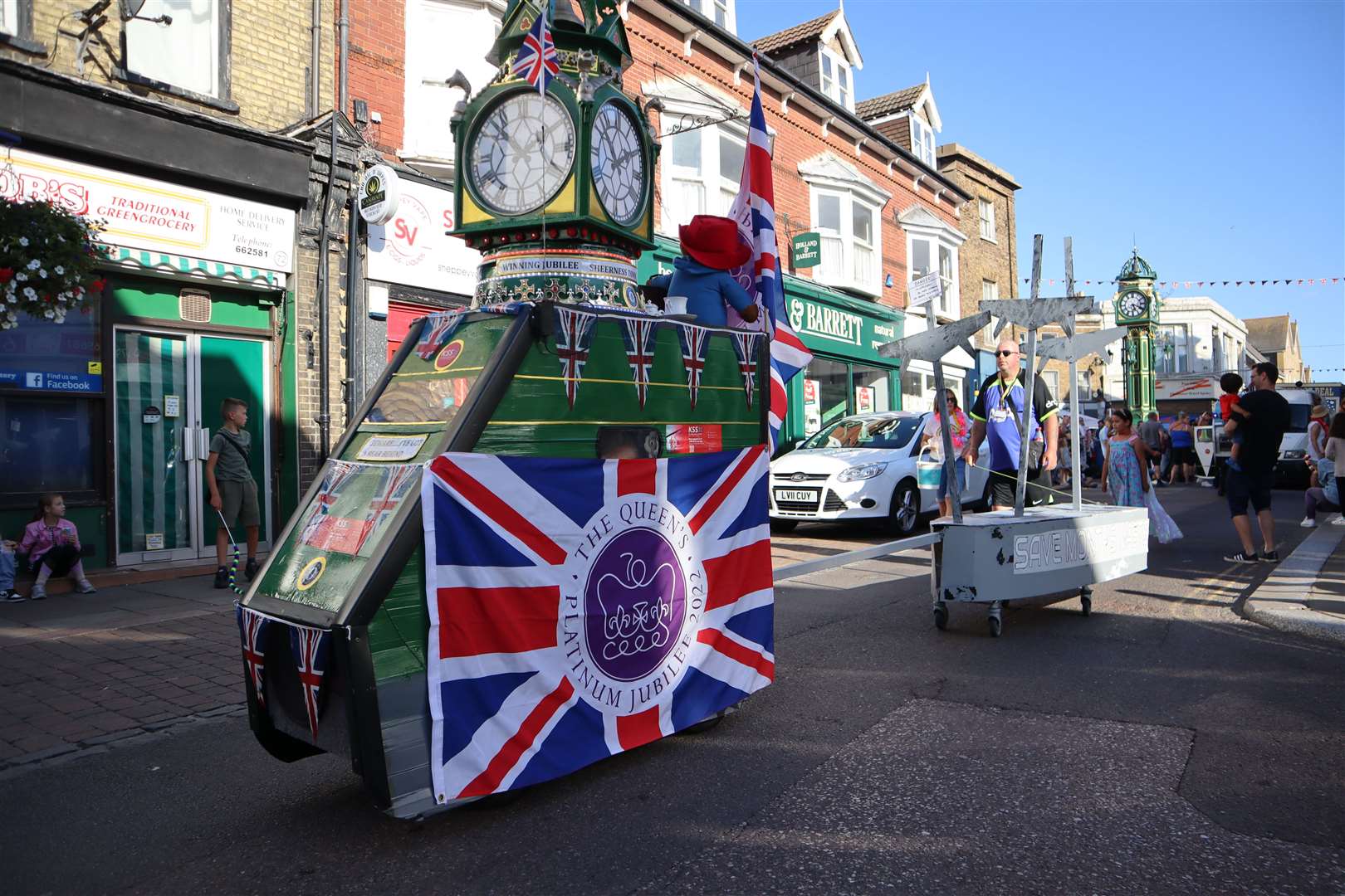 Tim Bell's replica Sheerness clock tower turned heads as it took part in the Sheppey summer carnival on Saturday towing a replica of the SS Richard Montgomery bomb ship followed by a snow-spouting Kent air ambulance helicopter