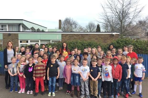 Melanie Smith with staff and pupils from Hempstead Junior and Infants Schools who helped raise money for her charity