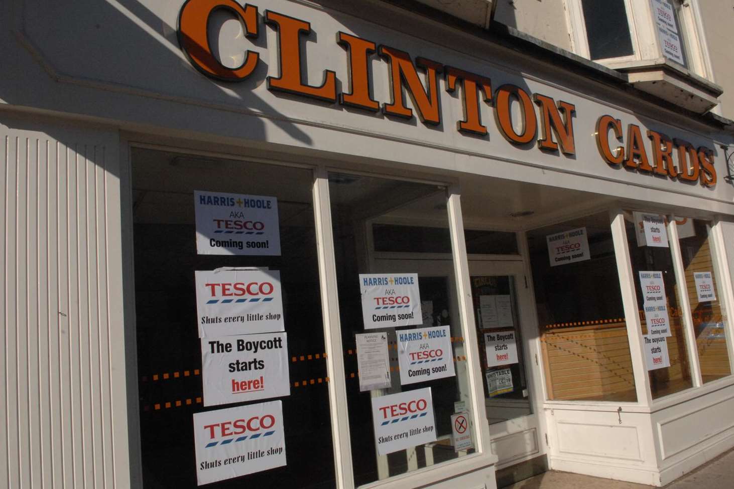 The former Clinton Cards shop was covered in anti-Tesco posters