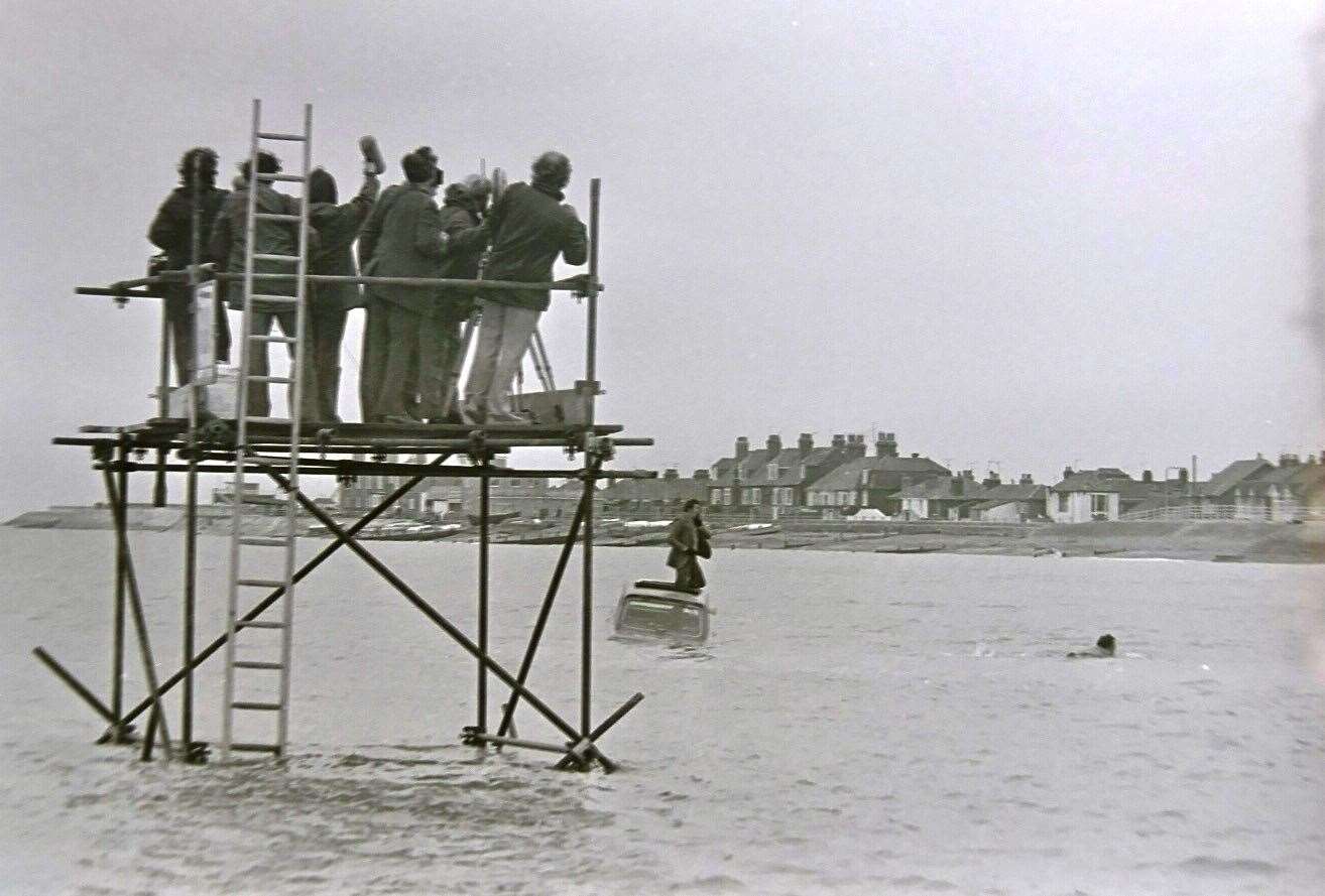 Film crew on scaffolding in the sea off Sheerness to capture Michael Crawford's car stunt for Some Mothers Do 'Ave 'Em. Picture: Barry Hollis