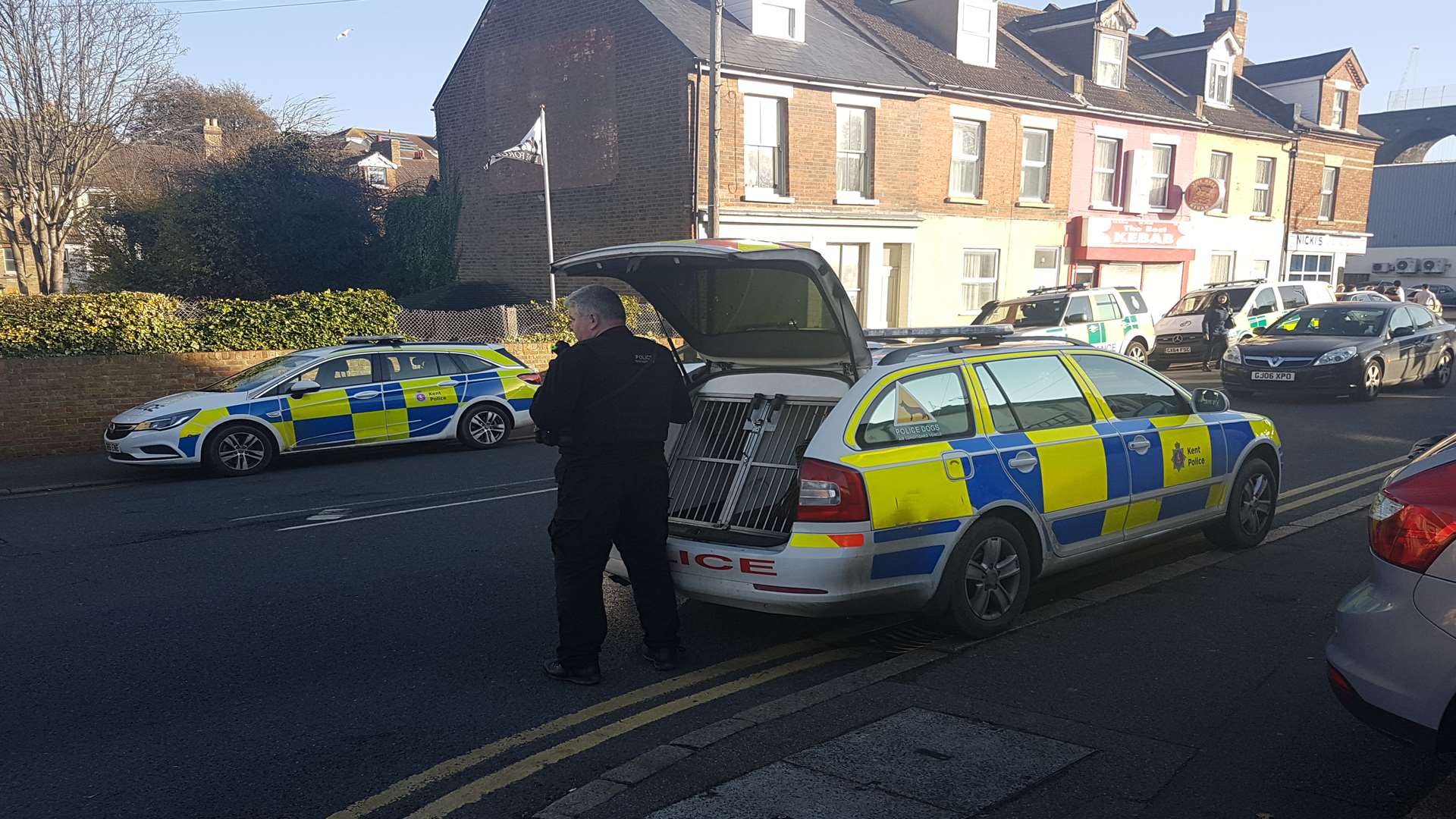 A dog handler at the scene. Picture: Sean Axtell