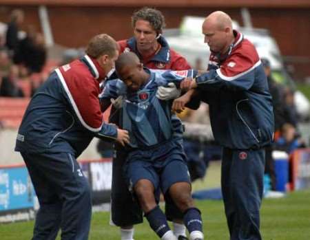 TURNING POINT: Yassim Moutaouakil is helped off the field by Charlton backroom staff. Pictures: BARRY GOODWIN