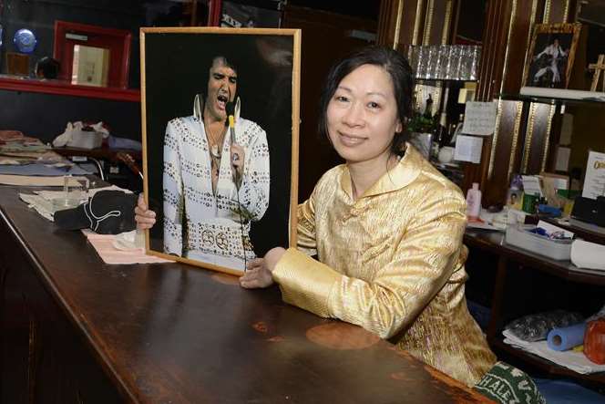 Tang's wife Shirley Ma hangs pictures of Elvis inside their Ashford bar