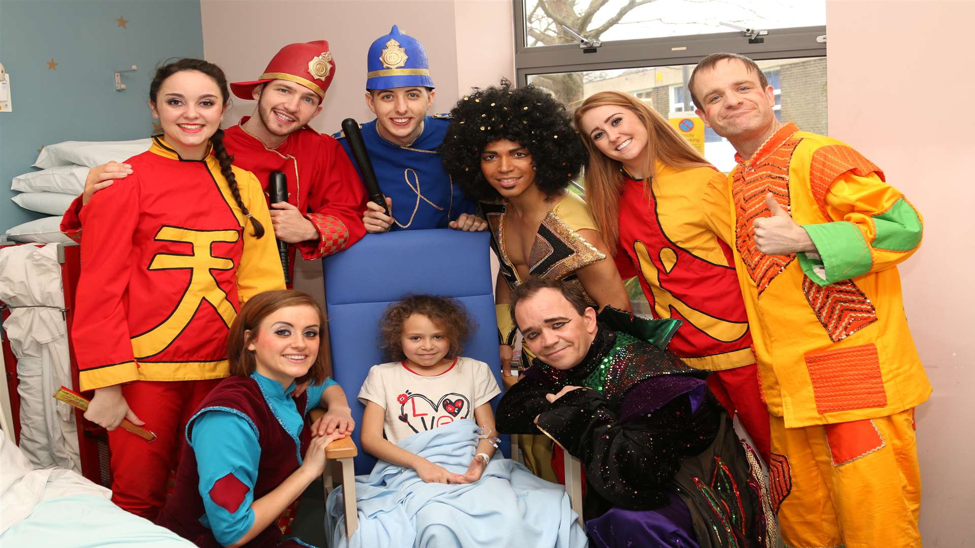 The cast of Aladdin led by Todd Carty, bottom right, visit young patients at Medway Maritime Hospital