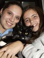 Alfie the cat, pictured with owners Sian and Alana Debnam. Picture: DAVE DOWNEY