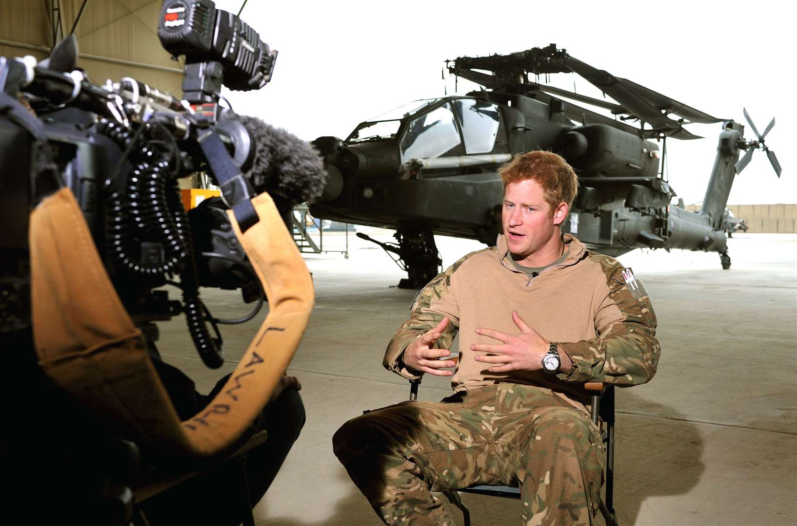 Harry being interviewed in an Apache repair hanger at Camp Bastion during his tour of duty in Afghanistan (John Stillwell/PA)