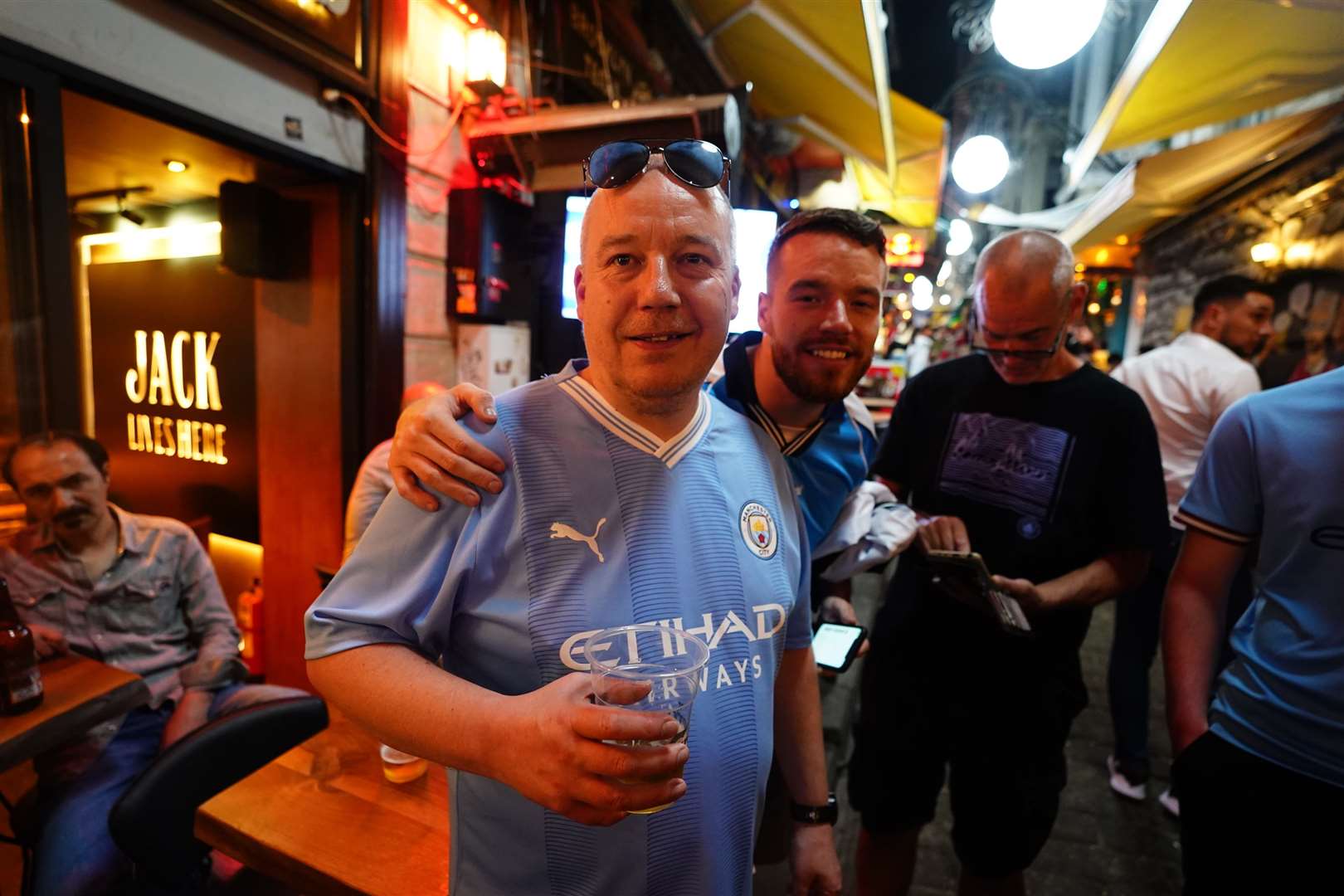 Man City fan Lee Webster, 51, (left) from Blackley, Manchester, celebrates (James Manning/PA)
