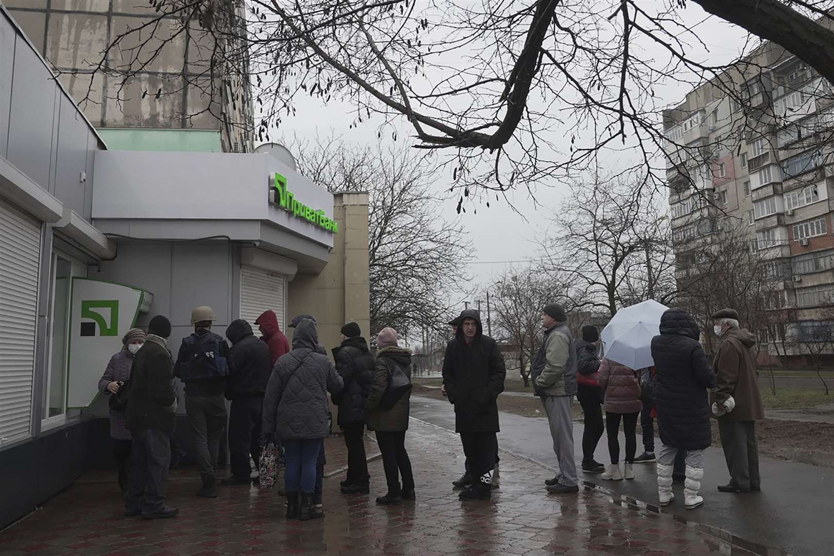 People queued in the streets of Ukraine to get their money from ATMs earlier today. Photo: AP/Evgeniy Maloletka