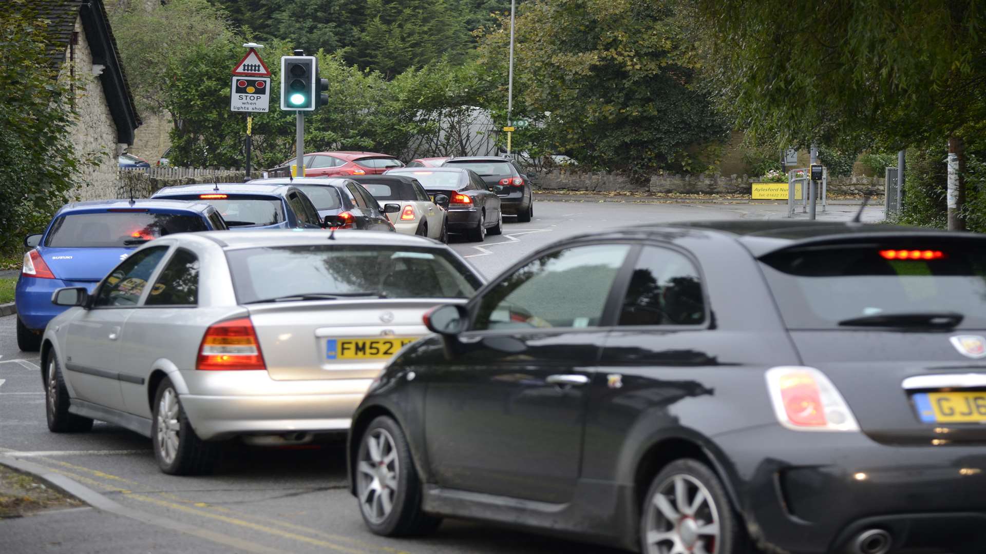 Traffic queueing in Aylesford due to the level crossing being down. Stock image