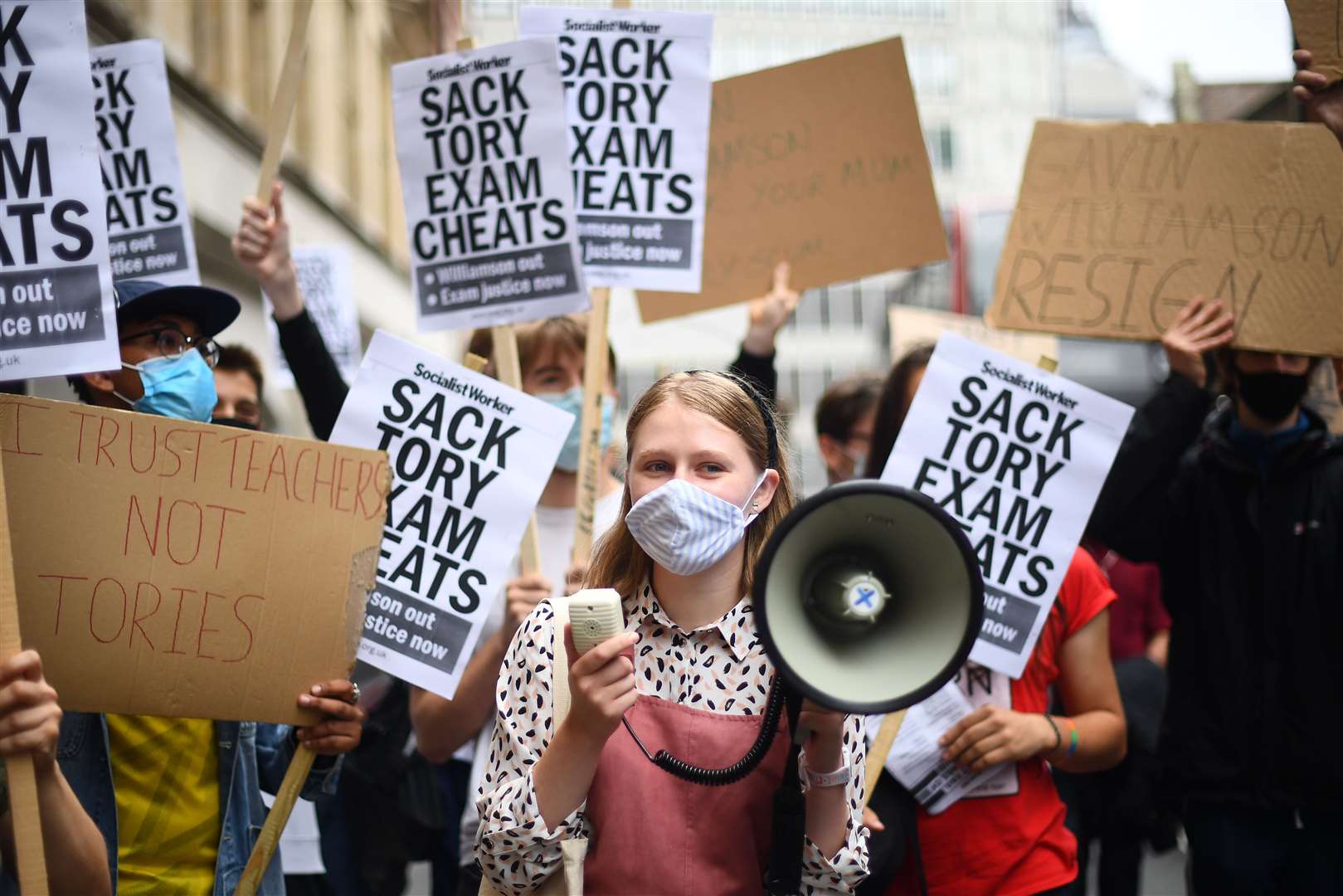People take part in a protest outside the Department for Education over A-level results (Victoria Jones/PA)