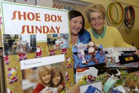 Mil Nuttall, left, and Liz Taylor help launch Trinity Community Church's shoebox appeal